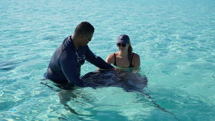 Two people holding a stingray