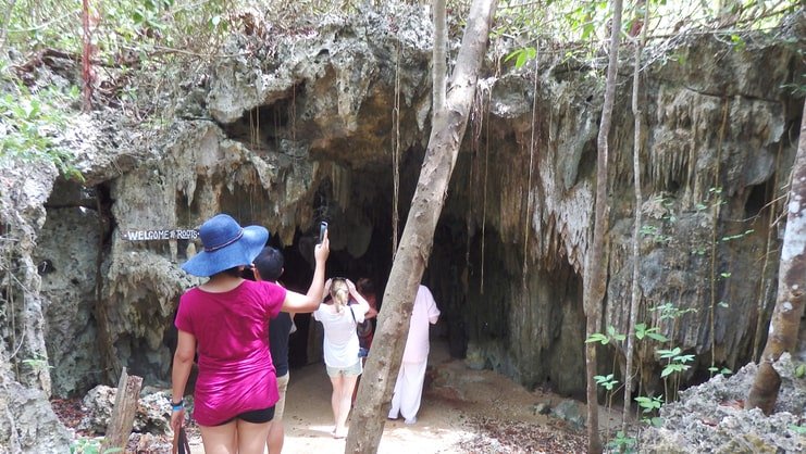 people standing outside caves