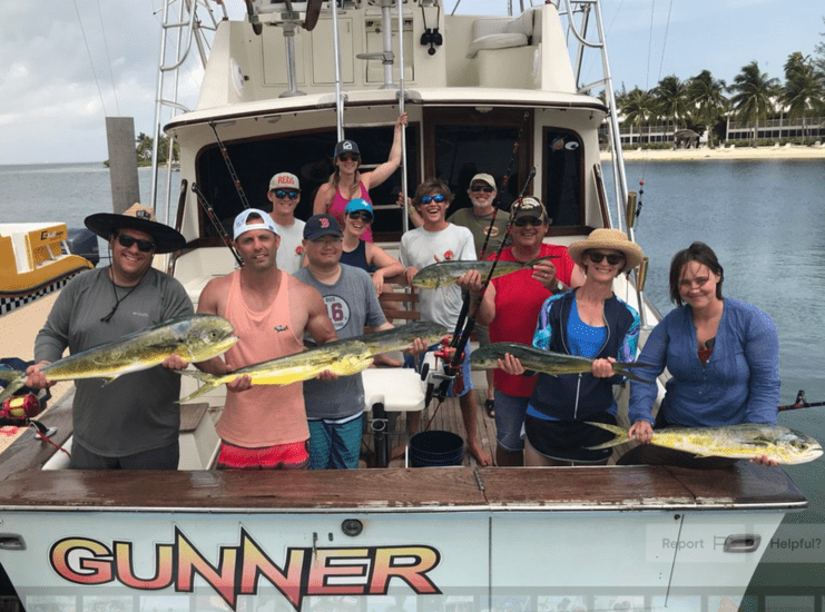 picture of ten people on boat holding fish