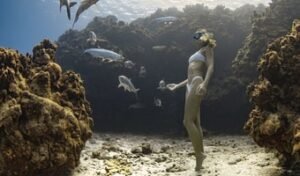 picture of woman standing on the seafloor underwater